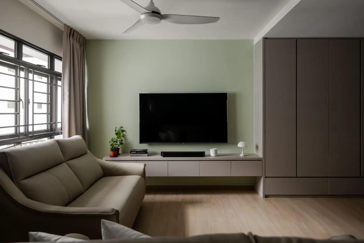 Living room with sage feature wall, 290C Compassvale