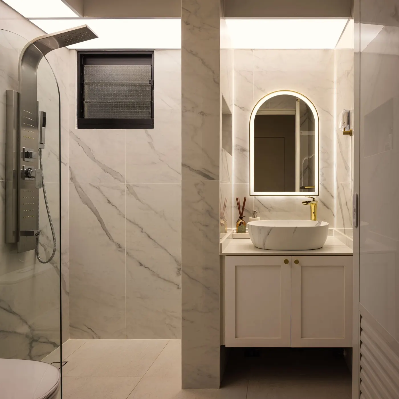 Common bathroom with marble-look walls and arched mirror, 265A Kim Keat