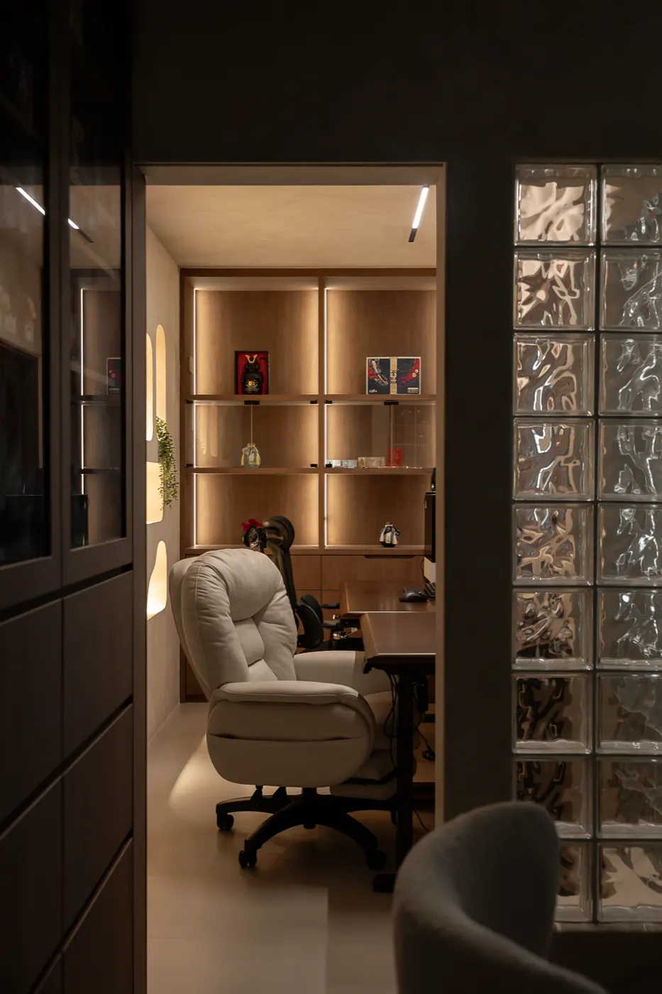 Lit display shelving beside glass blocks, 307B Tengah Drive