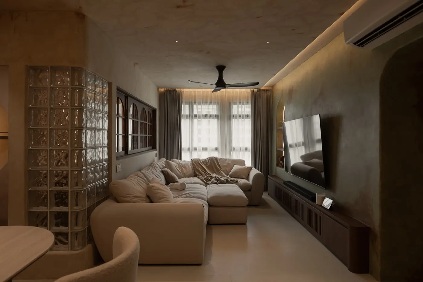 Living room with glass block wall and cove lighting, 307B Tengah Drive
