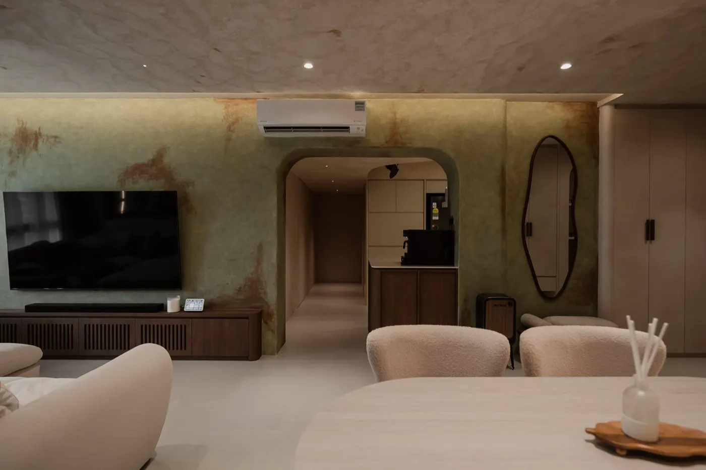 Living room with textured feature wall and arched doorway, 307B Tengah Drive