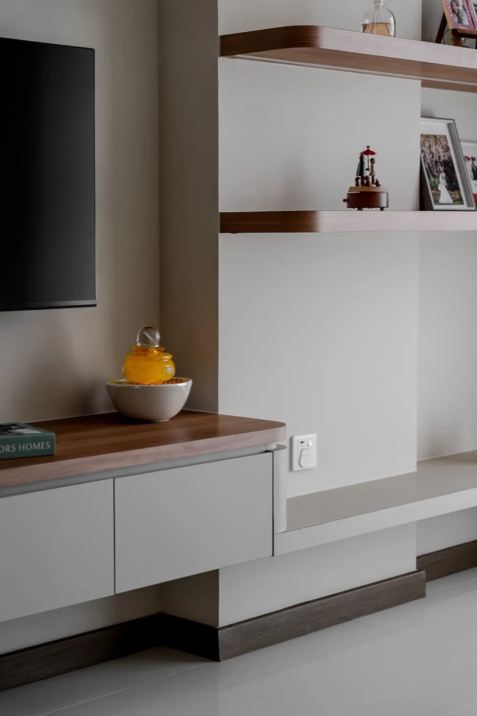 Floating walnut shelves beside the TV wall, Tengah Drive